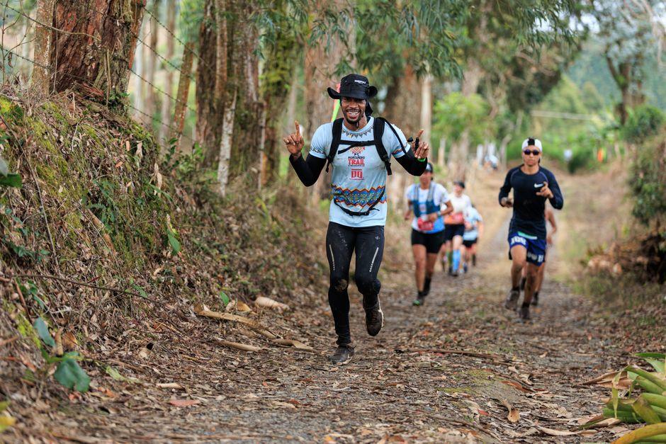 Trail runners racing through a forest path, enjoying the natural setting and camaraderie